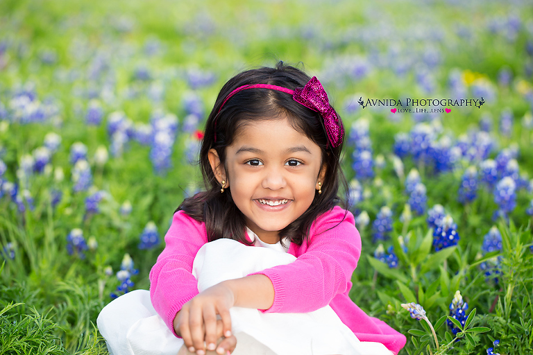 smiling in front of blue bonnets