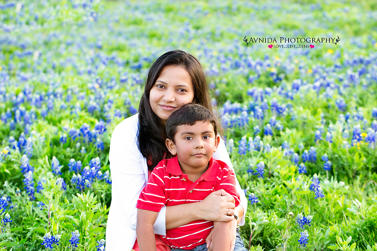 in mom's lap in the field of blue bonnets