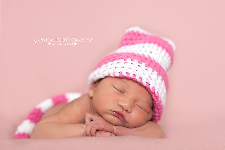 Karter in a pink and white cap in frisco newborn baby photographer