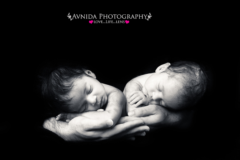 Brothers taking a nap in daddy's arms in this bridgewater nj twins newborn photography session