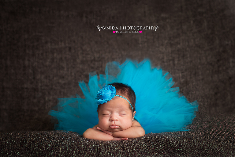 Newborn photography - baby resting chin peacefully on hands