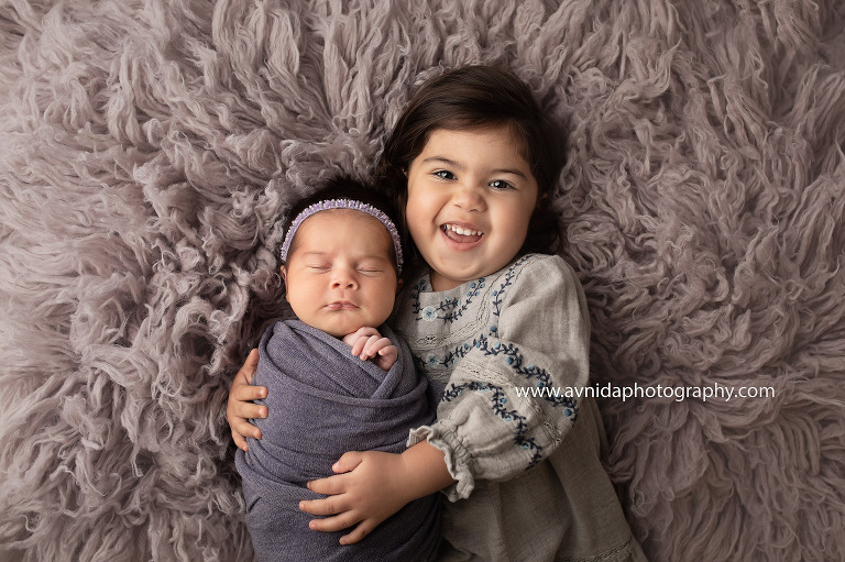 big sister has a blast with her sibling during the newborn photoshoot in New Jersey. This is what sibling love looks like.