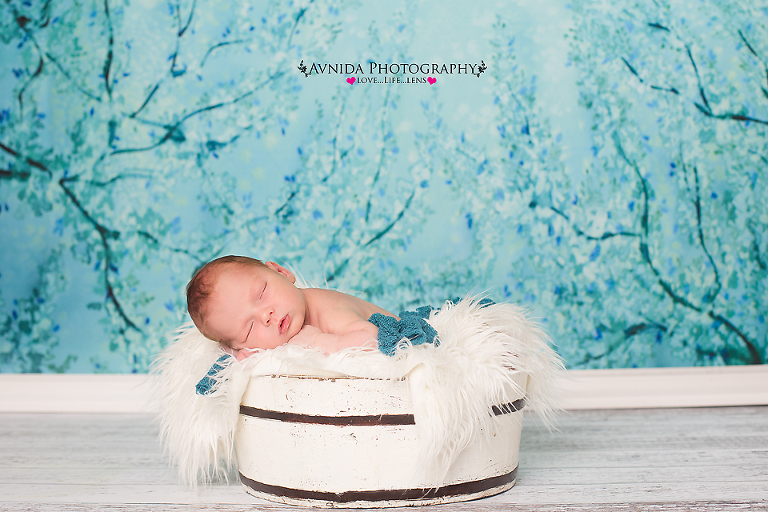 With turquoise background for his Newborn Baby Photography Ramsey New Jersey session