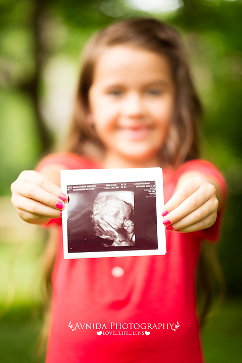 Sis showing off sonogram for maternity photography millburn new jersey