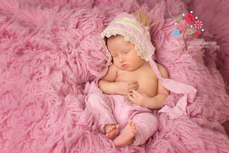 Newborn Photographer Hoboken New Jersey taking pictures of the baby in pink