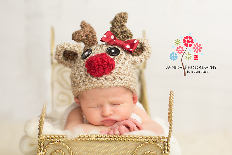 Newborn Photographer Hoboken New Jersey taking pictures of baby in an open sleigh