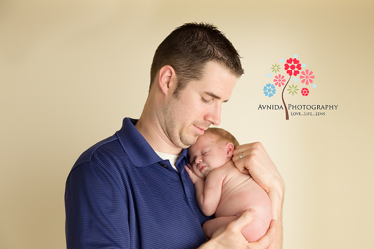 In Dad's arms - by Avnida Photography, a Premier Newborn Photographer NJ