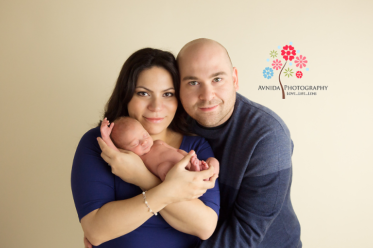 Newborn Photographer Warren NJ - in the arms of mom and dad - how cute