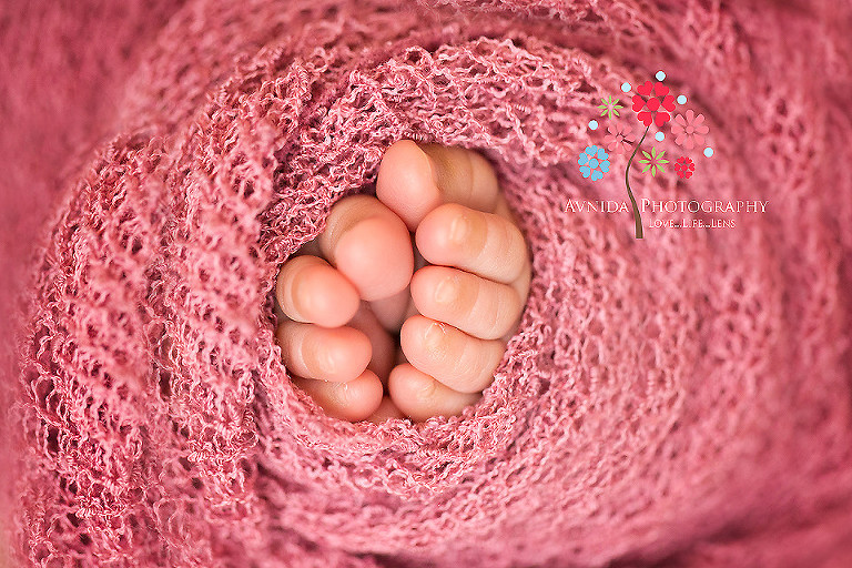 Zoe toes sticking out from underneath the blanket in picture from Newborn Photography Ocean County NJ by www.avnidaphotography.com