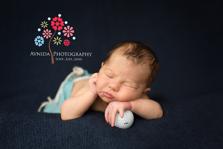 Newborn Photography Millburn NJ; posing with a golf ball