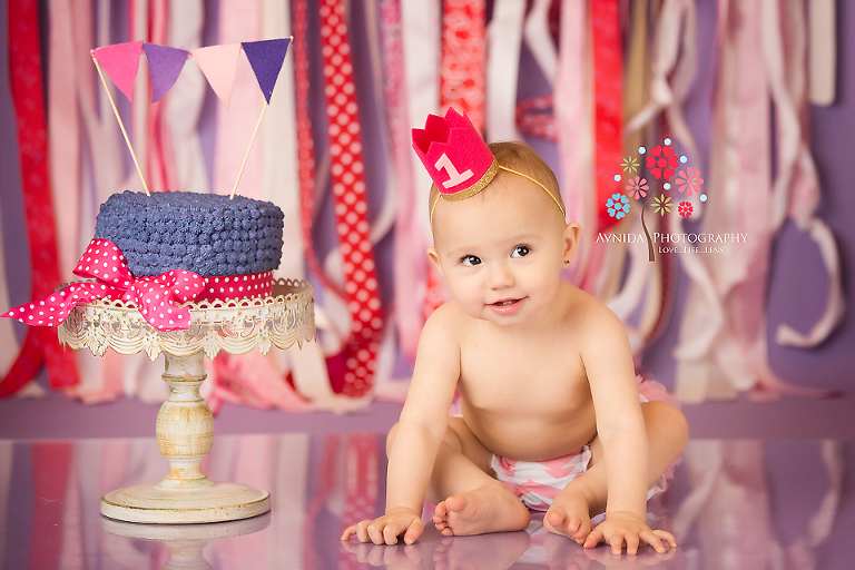 A cute hat with number one. A cake on the side.