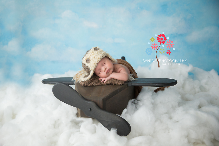 Nigel taking his plane into the clouds for his newborn baby photography session