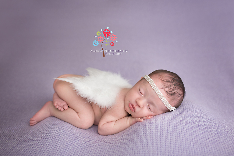 Viviana shows off her angel wings for her Newborn Baby Portrait