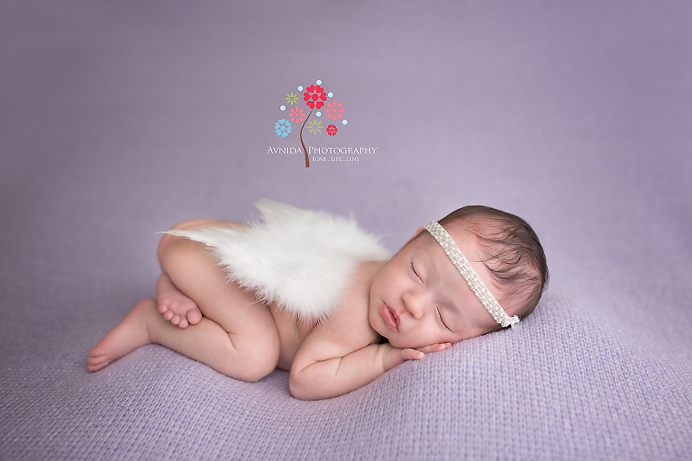Viviana shows off her angel wings for her Newborn Baby Portrait