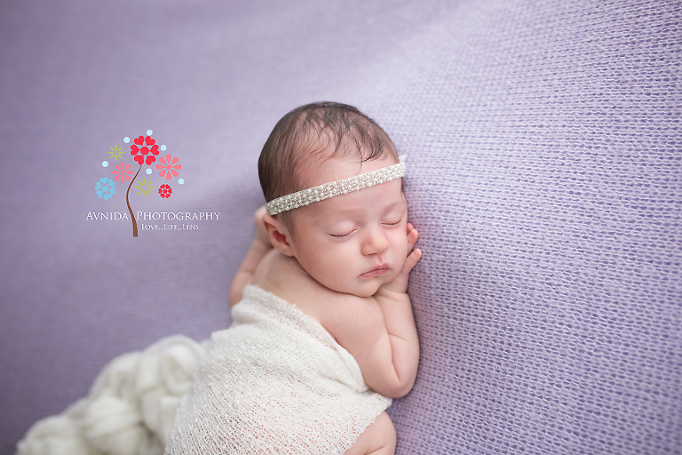 Viviana looks so blissful in a white headband and wrap for her Newborn Baby Portraits