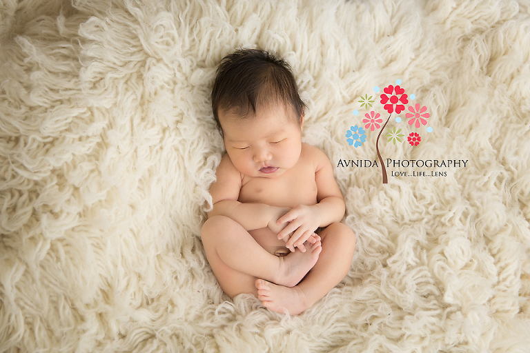 Floating in the ocean of flokati for her newborn photography session