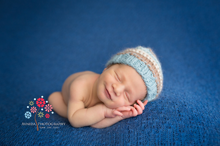Getting a newborn to smile for his newborn photography session. Newborn Picture Ideas by Avnida Photography.
