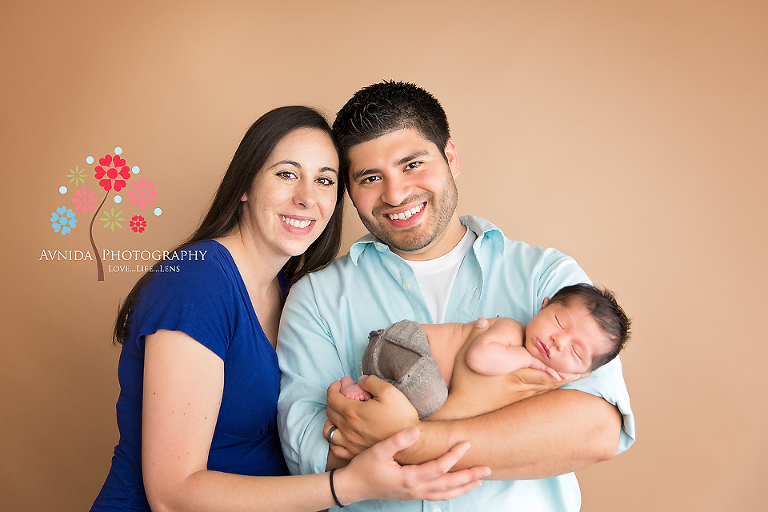 West Orange NJ newborn photographer - Mom and Dad are so happy holding little Martin in their hands