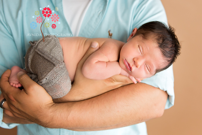 West Orange NJ newborn photographer - Sleeping peacefully in dad's arms