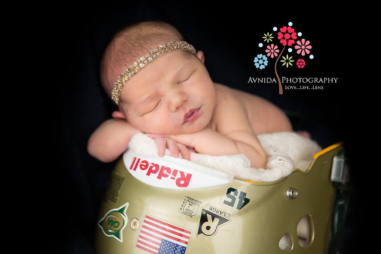Newborn Photographer Ridgewood NJ - A memory for dad with Charlotte posing in the football helmet