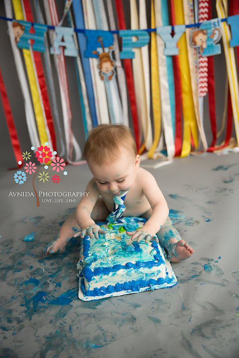 First Birthday Cake Smash - Like a Picasso, he slowly breathes art into the cake