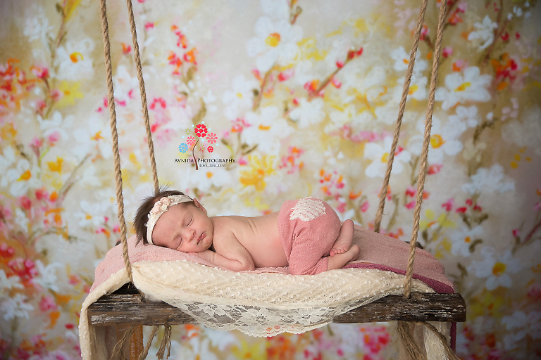 Newborn Photography Madison NJ - Those rare moments when this cute baby decided to take a nap during newborn photo session - a beautiful on the swing photo