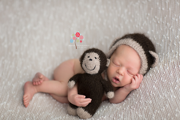 Newborn Photography Hillsborough NJ - There is an exciting conversation going on in that pretend phone he is holding up in the left hand - "Woow and then he said what"