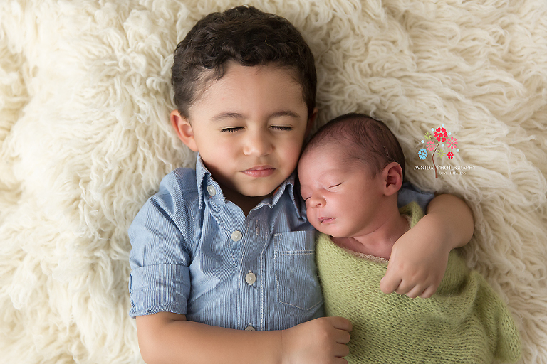 Newborn Photography Englewood NJ - This one just cracked me up - You have to give the big brother points for trying really hard to close his eyes and pretend to fall asleep