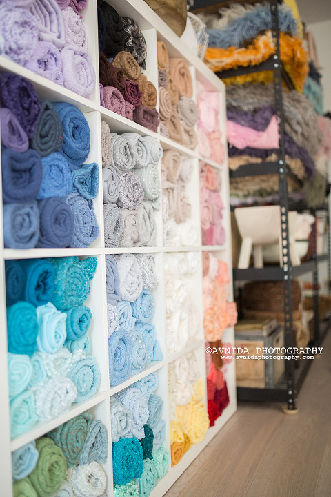 A wide selection of blankets organized by color in our newborn photography studio