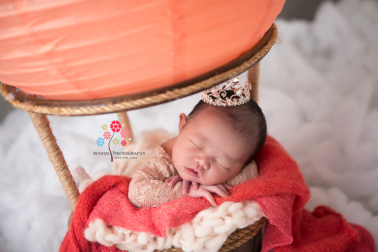 Newborn Photography Lawrenceville NJ - A little close-up of the little princess with overflowing red blanket representing a nice breeze blowing by