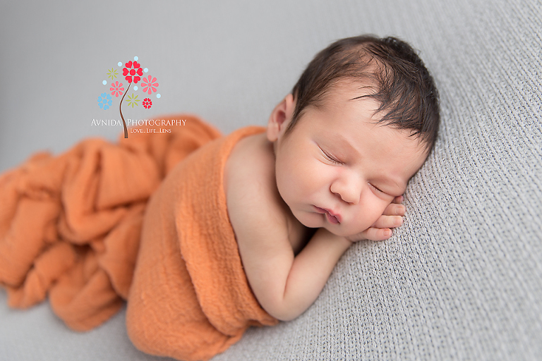 Newborn Photography Red Bank NJ - Remember what I told you about contrasting newborn photos - this is why - the contrast between the bright orange and the neutral grey just make the photo pop