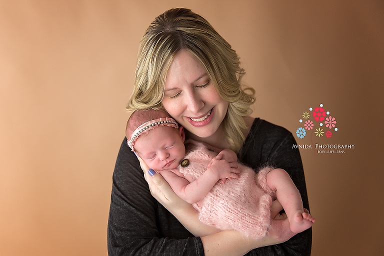 Newborn Photography Franklin NJ - I am complete love with this photograph - the smile on mom's face, the "i am so rested" look on Emma, especially with the hands folded across each other