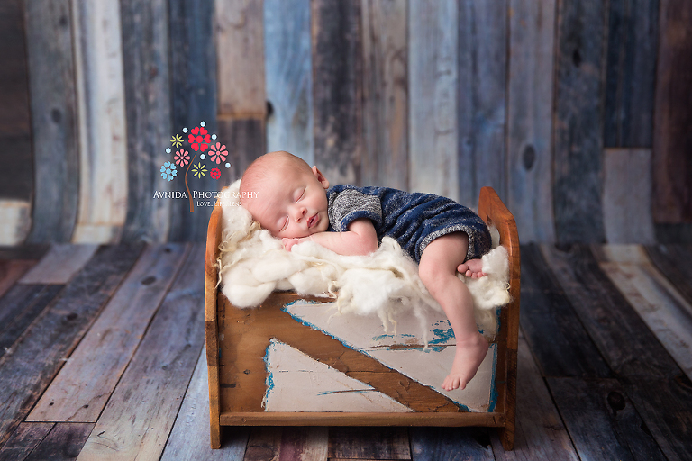 Basking Ridge Newborn Photography NJ - Leg hanging over the side, Baby Jackson is sleeping peacefully on the coolest baby bed we've ever seen