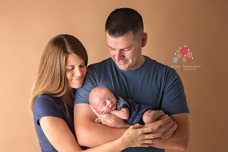 Basking Ridge Newborn Photography NJ - One of my favorite photographs from the session. One of my favorite photographs from the session - the family is color coordinated with slightly different shades of blue and their affection just comes through so clearly.