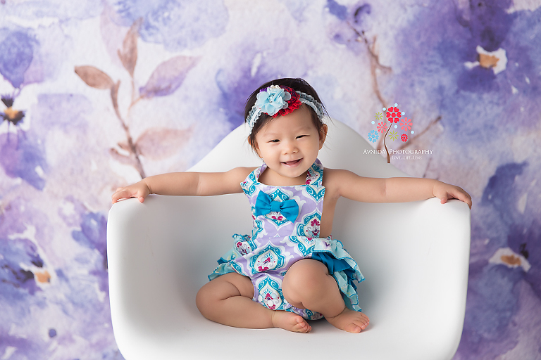 Cake Smash Photography Haworth NJ - Now that is what we call a smile and a pose - like a princess she stretches her arms like she is sitting on a throne