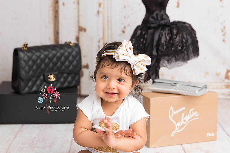 Cake Smash Photography Saddle River NJ - Slowly but surely, we see a transformation - Baby Ahayli is now all excited, smiling and happy about her new Christian Louboutin shoes