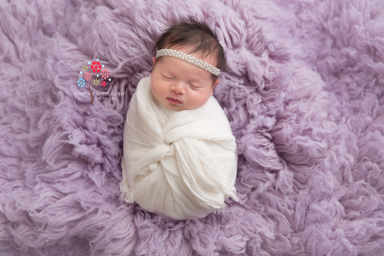 Newborn Photography Spring Lake NJ - A little bundle of joy, wrapped in white against an equally beautiful lavender blanket