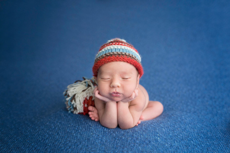 Newborn Photography Oldwick NJ - Another pose executed perfectly by Omer - doesn't this shade of blue brighten up the photo