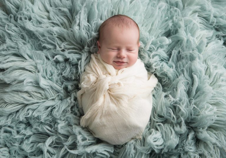 That smirk, that smile, the perfect expression during newborn photography. Patience and training that only comes after you done 400+ newborn photo sessions.