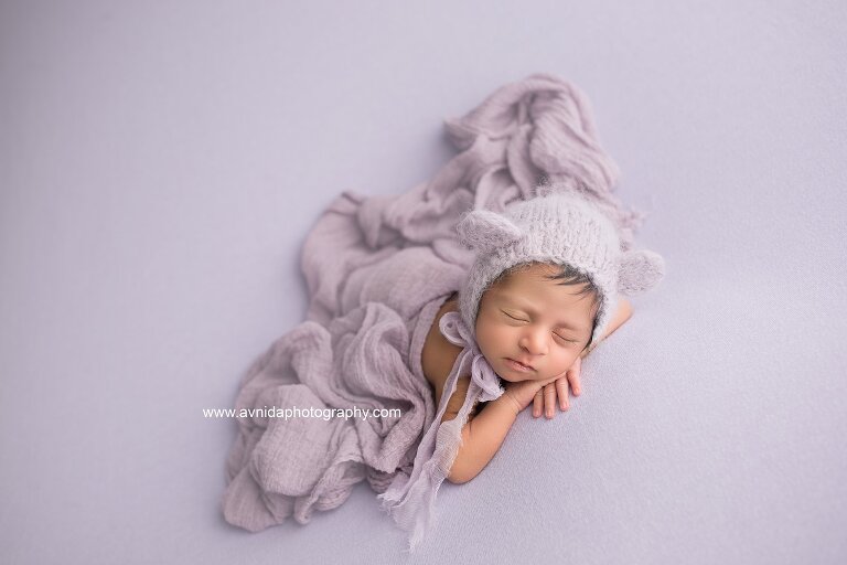 Best Newborn Photographer NJ - baby in gentle lavender color blanket