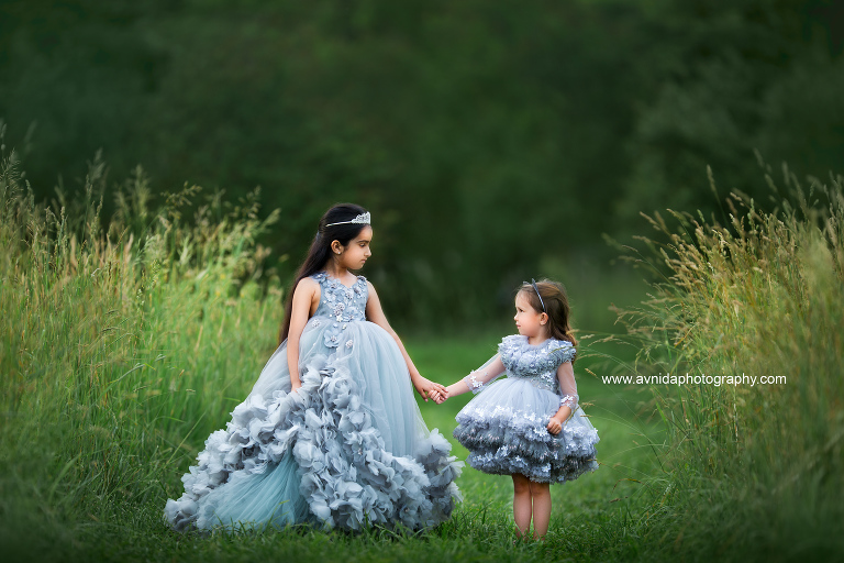Children's Couture Photography - The two princesses walk hand in hand, one teaching the other all about values and style.