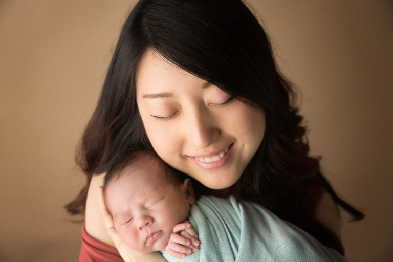 Mom is super happy holding her little bundle of joy close to her heart.