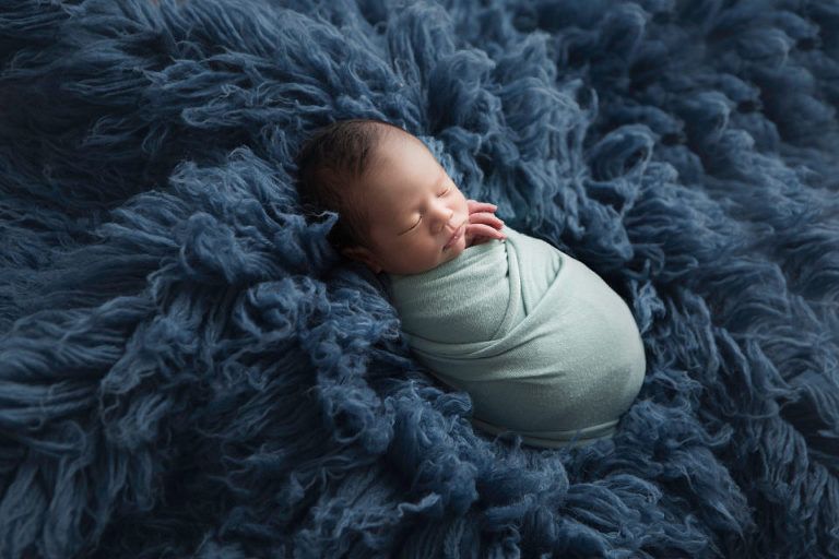 Newborn Photography Westfield NJ session by Avnida Photography. Sleeping in a blue sea of calmness and tranquility, rocked by the waves.