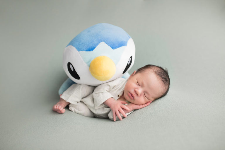 Newborn Photography Westfield NJ session by Avnida Photography. The Penguin looks over friend wondering when he will wake up to play.