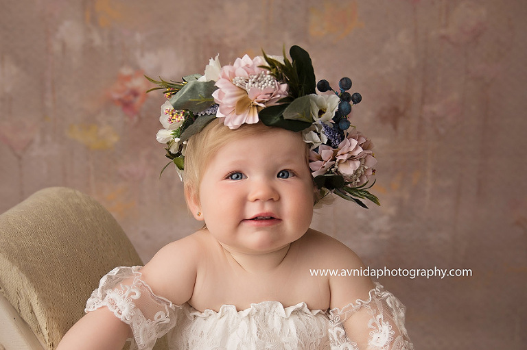 The queen - at least, until the big sister hasn't arrived - smiles gently for her royal portrait. A very special portrait session.