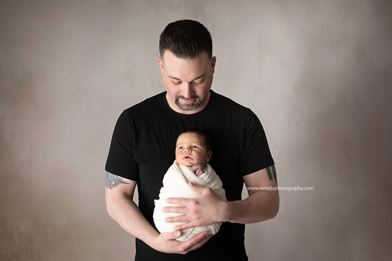 Newborn Photography East Hanover NJ - wide awake, and feeling safe and loved in his dad's arms